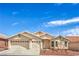 Inviting single-story home featuring a three-car garage, desert landscaping, and neutral stucco exterior at 8664 Frasure Falls Ave, Las Vegas, NV 89178