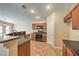 Charming kitchen with wood cabinets, black appliances, and breakfast bar at 8664 Frasure Falls Ave, Las Vegas, NV 89178