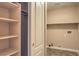 Laundry room with built-in shelves and tile floors at 8664 Frasure Falls Ave, Las Vegas, NV 89178