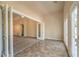 Spacious living room with neutral tones, tile flooring, and double french doors to another room at 8664 Frasure Falls Ave, Las Vegas, NV 89178