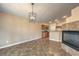 Large living room featuring a modern light fixture, tile floor, and access to the kitchen at 8664 Frasure Falls Ave, Las Vegas, NV 89178
