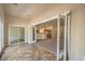 Open floorplan living room featuring tile floors, open doorway to kitchen, and access to outdoor patio at 8664 Frasure Falls Ave, Las Vegas, NV 89178
