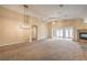 Spacious living room with high ceilings, a fireplace, and neutral carpet and paint at 8664 Frasure Falls Ave, Las Vegas, NV 89178