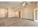 Spacious living room with high ceilings, neutral carpet, and multiple entryways at 8664 Frasure Falls Ave, Las Vegas, NV 89178