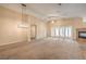 Spacious living room with high ceilings, a fireplace, and neutral carpet and paint at 8664 Frasure Falls Ave, Las Vegas, NV 89178