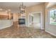 Spacious living room boasts a fireplace, tile floors, and access to both the kitchen and patio at 8664 Frasure Falls Ave, Las Vegas, NV 89178