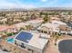 Beautiful aerial view of a home with pool, solar panels, and well-maintained landscaping in a desirable neighborhood at 8911 Lansberry Ct, Las Vegas, NV 89147