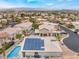 Expansive aerial view of a house with solar panels nestled within a neighborhood, offering a peek at community living at 8911 Lansberry Ct, Las Vegas, NV 89147