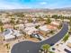 Captivating aerial view of a community, highlighting a desert home with solar panels and mature landscaping at 8911 Lansberry Ct, Las Vegas, NV 89147