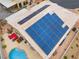 Great view of the home's solar panels, inground pool, and outdoor seating at 8911 Lansberry Ct, Las Vegas, NV 89147