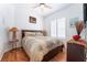 Bedroom featuring a wood frame bed, decorative lamps, and wood floors at 8911 Lansberry Ct, Las Vegas, NV 89147