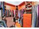 Walk-in closet with wood floors, built-in shelving, and hanging rods for organized storage at 8911 Lansberry Ct, Las Vegas, NV 89147