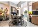 The dining area overlooks the backyard pool and patio with natural light and stylish decor at 8911 Lansberry Ct, Las Vegas, NV 89147