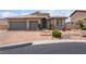 Charming home featuring a landscaped front yard, a paver driveway and a three-car garage at 8911 Lansberry Ct, Las Vegas, NV 89147