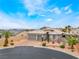 Beautiful home featuring a two-car garage, desert landscaping, and elegant entryway at 8911 Lansberry Ct, Las Vegas, NV 89147