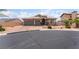 Charming home featuring a landscaped front yard, a paver driveway and a three-car garage at 8911 Lansberry Ct, Las Vegas, NV 89147