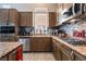 Well-lit kitchen features stainless steel appliances, granite countertops, and stylish tile backsplash at 8911 Lansberry Ct, Las Vegas, NV 89147