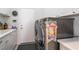 Laundry room with stainless steel washer and dryer, white cabinets, and sink at 8911 Lansberry Ct, Las Vegas, NV 89147