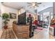 Living room with a large tv and natural lighting with an open floor plan at 8911 Lansberry Ct, Las Vegas, NV 89147