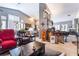 Open-concept living room featuring a fireplace, bar area, and comfortable seating with wood floors at 8911 Lansberry Ct, Las Vegas, NV 89147