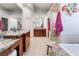 Large main bathroom with double sinks, granite countertops, and a separate glass shower and tub at 8911 Lansberry Ct, Las Vegas, NV 89147