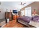 Spacious main bedroom with a ceiling fan, shuttered windows, and classic wood furniture at 8911 Lansberry Ct, Las Vegas, NV 89147