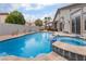 Backyard pool and spa with lush landscaping and privacy walls at 8911 Lansberry Ct, Las Vegas, NV 89147