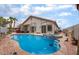 Private backyard pool with jacuzzi and desert landscaping offering a relaxing outdoor oasis at 8911 Lansberry Ct, Las Vegas, NV 89147