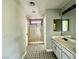 Bathroom featuring decorative floor tile, shower with glass door, and vanity with sink and mirror at 8990 Partridge Hill St, Las Vegas, NV 89148
