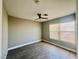 Bedroom featuring wood-look floors, a ceiling fan, neutral walls, and a bright window with privacy blinds at 8990 Partridge Hill St, Las Vegas, NV 89148