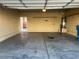 Spacious garage with ample room for parking, storage shelves, and an entry door to the house at 8990 Partridge Hill St, Las Vegas, NV 89148