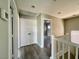 Upstairs hallway showcasing wood flooring and white-painted doors at 8990 Partridge Hill St, Las Vegas, NV 89148