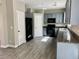 Modern kitchen featuring gray cabinets, granite countertops, and stainless steel appliances at 8990 Partridge Hill St, Las Vegas, NV 89148