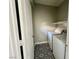 Laundry room featuring tile flooring, washer and dryer, and a white storage shelf at 8990 Partridge Hill St, Las Vegas, NV 89148