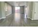 Bright, open-concept living room with gray wood floors, and sliding glass doors that fill the room with light at 8990 Partridge Hill St, Las Vegas, NV 89148