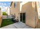 A well kept backyard features a concrete patio, sliding glass door, and a patch of lush artificial turf at 9019 Winchester Ridge St, Las Vegas, NV 89139