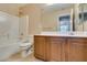 Bright bathroom featuring a tub, shower, vanity and neutral tile flooring at 9019 Winchester Ridge St, Las Vegas, NV 89139