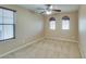 Neutral bedroom with carpet, ceiling fan, and large windows at 9019 Winchester Ridge St, Las Vegas, NV 89139
