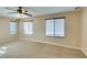 Large, neutral bedroom with carpet, ceiling fan and many windows at 9019 Winchester Ridge St, Las Vegas, NV 89139