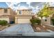 Two-story home boasts a front-facing two-car garage and stone veneer accents at 9019 Winchester Ridge St, Las Vegas, NV 89139