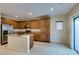 Well-equipped kitchen featuring stainless steel appliances, a center island, and tile floors at 9019 Winchester Ridge St, Las Vegas, NV 89139
