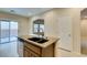 Spacious kitchen with stainless dishwasher in the kitchen island and sliding doors to the patio at 9019 Winchester Ridge St, Las Vegas, NV 89139