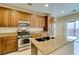 Modern kitchen boasting stainless steel appliances, granite countertops, and a double sink at 9019 Winchester Ridge St, Las Vegas, NV 89139