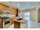 Modern kitchen with a stainless steel range and a sink in the center island at 9019 Winchester Ridge St, Las Vegas, NV 89139