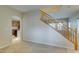 Open-concept room with wood staircase, neutral walls, and plush carpet at 9019 Winchester Ridge St, Las Vegas, NV 89139
