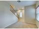 Open-concept room with wood staircase, neutral walls, and plush carpet at 9019 Winchester Ridge St, Las Vegas, NV 89139