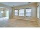 Bright and airy living room with neutral walls, plush carpet, and sliding glass doors at 9019 Winchester Ridge St, Las Vegas, NV 89139