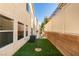 Clean side yard with artificial turf and privacy fence that is easy to maintain and keep clean at 9019 Winchester Ridge St, Las Vegas, NV 89139