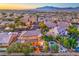Beautiful neighborhood view featuring a two-story home with a lush backyard, pool, and putting green at 9805 Turtle Walk Ave, Las Vegas, NV 89149
