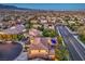 Expansive aerial shot of a neighborhood highlighting a home with a backyard pool and mountain views at 9805 Turtle Walk Ave, Las Vegas, NV 89149